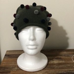 Olive green beanie with grey red and blue Pom poms